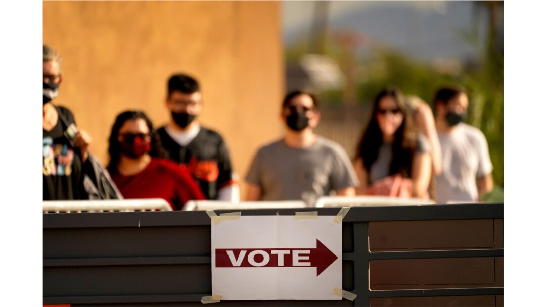 Voters stand in line outside a polling station on Election Day, in Mesa, Arizona, Nov. 3, 2020.