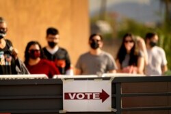 Voters stand in line outside a polling station on Election Day, in Mesa, Arizona, Nov. 3, 2020.