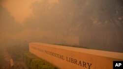 Smoke engulfs the Ronald Reagan Library during the Easy Fire, Oct. 30, 2019, in Simi Valley, Calif. A new wildfire erupted Wednesday in wind-whipped Southern California, forcing the evacuation of the library and nearby homes.