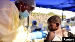 FILE - A Congolese health worker administers Ebola vaccine to a child at the Himbi Health Centre in Goma, Democratic Republic of Congo, July 17, 2019. 