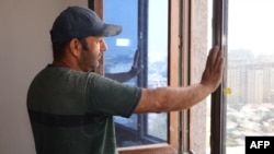 FILE- Tajik construction worker Zoir Kurbanov renovates a new apartment in Dushanbe, Sept. 17, 2023. While Russia has remained an attractive destination for Central Asian workers -- 1.3 million migrated from Kyrgyzstan, Tajikistan and Uzbekistan in the first quarter of 2023.