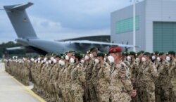 German soldiers line up for the final roll call in front of a German armed forces Bundeswehr Airbus A400M cargo plane after returning from Afghanistan at the airfield in Wunstorf, Germany, June 30, 2021.