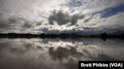 FILE - Clouds are reflected in the Whanganui River at the town of Whanganui, New Zealand, on June 17, 2022.