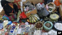 A Libyan woman sells traditional products at a stall along a street in downtown Tripoli, Libya, October 30, 2011.