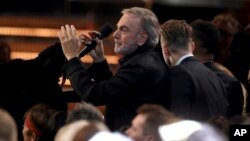 Neil Diamond leads a carpool karaoke performance of "Sweet Caroline" at the 59th annual Grammy Awards, Feb. 12, 2017, in Los Angeles.