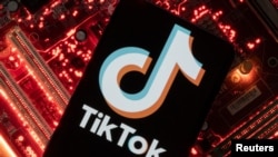 FILE: A smartphone with a displayed TikTok logo is placed on a computer motherboard in this illustration taken Feb. 23, 2023.