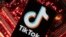 FILE: A smartphone with a displayed TikTok logo is placed on a computer motherboard in this illustration taken Feb. 23, 2023.