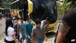 FILE - A group of Salvadoran deportees arrive at La Chacra Immigration Center in San Salvador, El Salvador, June 28, 2018.