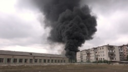 Black smoke rises near buildings during a military conflict over the breakaway region of Nagorno-Karabakh, in Stepanakert, Oct, 4, 2020 in this still image taken from video obtained on October 6, 2020.