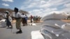 Zimbabwean women collect food aid from a distribution point in Mutawatawa, about 220km northeast of the capital Harare, November 25, 2013. 