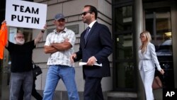 Former Donald Trump presidential campaign adviser George Papadopoulos, center, who triggered the Russia investigation, leaves federal court with wife Simona Mangiante, Sept. 7, 2018, in Washington. 