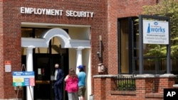 FILE - Job seekers line up outside the New Hampshire Works employment security job center, in Manchester, New Hampshire, May 10, 2021. 