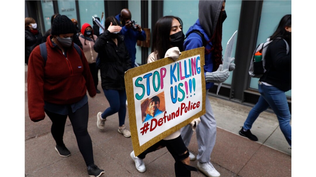 A protester navigates along Chicago's Loop during a peaceful protest, April 14, 2021, ahead of the video release of the fatal police shooting of 13-year-old Adam Toledo.