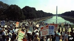 People carry civil rights signs as they gather in Washington, D.C. before Martin Luther King Jr.'s "I Have a Dream" speech on Aug. 28, 1963.