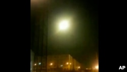 FILE _ This image taken from a video on Jan. 8, 2020 shows an object said to be the Ukrainian jetliner flying in sky at the moment of explosion with a flash of light. 