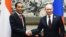 Russian President Vladimir Putin (r) shakes hands with Indonesian President Joko Widodo at the Asia-Pacific Economic Cooperation (APEC) forum in Beijing, Nov. 10, 2014. 