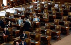 Empty seats are seen in the House Chamber at the Texas Capitol, July 13, 2021.