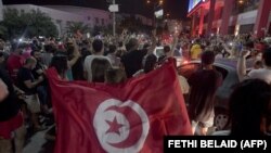 La foule salue la dissolution du parlement et du gouvernement du premier ministre Hichem Mechichi par le président tunisien Kais Saied à Tunis, le 25 juillet 2021, après une journée de protestation dans tout le pays.