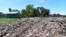 The Dandora Secondary school, next to a mountain of garbage and smoke from burning trash at Dandora, the largest garbage dump in the capital Nairobi, Kenya, April 22, 2024. Students have planted more than 100 seedlings along the wall that separates the school from the dump.