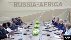 Russian President Vladimir Putin meets with his Ugandan counterpart Yoweri Museveni during the second Russia-Africa summit in Saint Petersburg on July 27, 2023. (Photo by Kirill KUKHMAR / TASS Host Photo Agency / AFP)