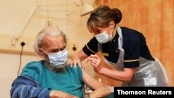 A man receives the Oxford University/AstraZeneca COVID-19 vaccine at the Churchill Hospital in Oxford, Britain, Jan. 4, 2021.