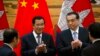 In this photo taken on Jan. 22, 2019, Cambodian Prime Minister Hun Sen, center left, applauds with Chinese Premier Li Keqiang during a signing ceremony at the Great Hall of the People in Beijing, China.