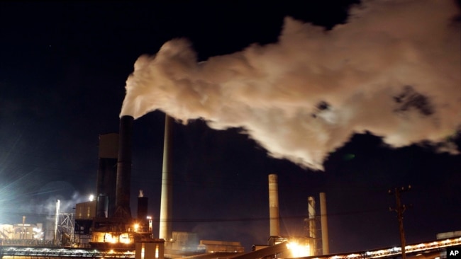 In this July 8, 2011 file photo, smoke bellows from a chimney stack at BlueScope Steel's mill at Port Kembla, south of Sydney, Australia.