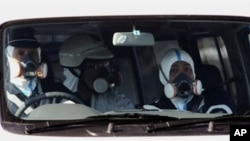 Policemen wear gas masks and patrol near the nuclear power plant in Fukushima prefecture on March 12, 2011 a day after a massive 8.9 magnitude quake and tsunami hit the region.