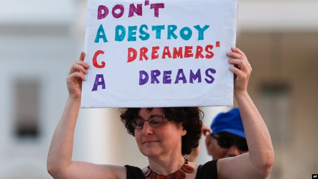 Trump ImmigrationJulia Paley, of Arlington, Va., with the DMV Sanctuary Congregation Network, holds up a sign during a rally supporting Deferred Action for Childhood Arrivals, or DACA, outside the White House in Washington, Sept. 4, 2017. 