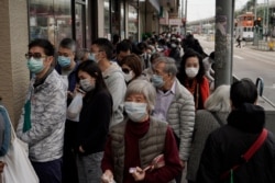 People queue up to buy face masks in Hong Kong, Feb. 7, 2020.