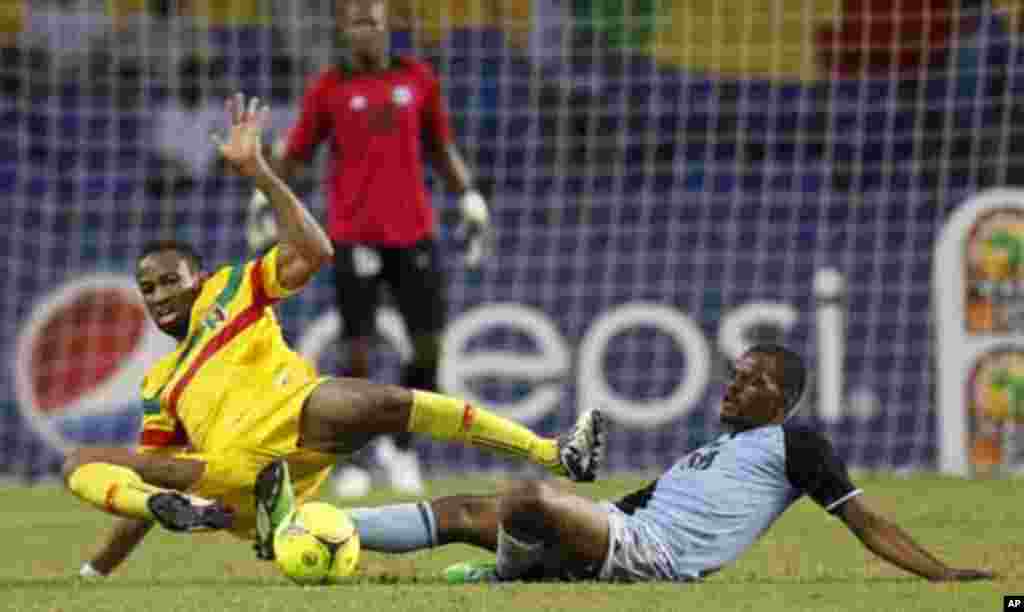 Mali's Seydou Keita (12) is tackled by Botswana's Mogogi Gabonamong during their final African Cup of Nations Group D soccer match at the Stade De L'Amitie Stadium in Libreville February 1, 2012.