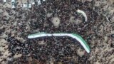 People carry Syrian opposition flags during a rally marking the 10th anniversary of the start of the Syrian conflict, in opposition-held Idlib, Syria, March 15, 2021.