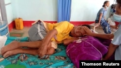 A coronavirus disease (COVID-19) patient is comforted by a family member at the hospital in Cikha, Myanmar, May 28, 2021.