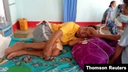 A coronavirus disease (COVID-19) patient is comforted by a family member at the hospital in Cikha, Myanmar, May 28, 2021.