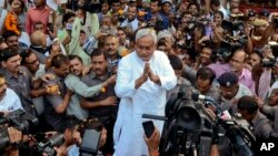 FILE - Bihar Chief Minister Nitish Kumar (C) is surrounded by media personnel as he greets supporters after victory in Bihar state elections in Patna, India, Nov. 8, 2015. 