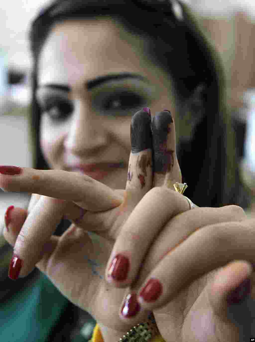 Two Syrian women display their stained fingers after voting in parliamentary elections in Damascus, May 7, 2012. (Reuters)