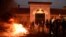 Wooden pallets burn as prison guards block access to Fresnes prison, Jan. 16, 2018, to demand tighter security after three officers were injured in an attack by Christian Ganczarski, a German terror convict. Ganczarski is serving an 18 year sentence in the 2002 bombing of a Tunisian synagogue.