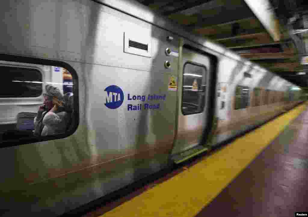 People ride the last train to Long Island as it departs Penn Station in New York October 28, 2012.