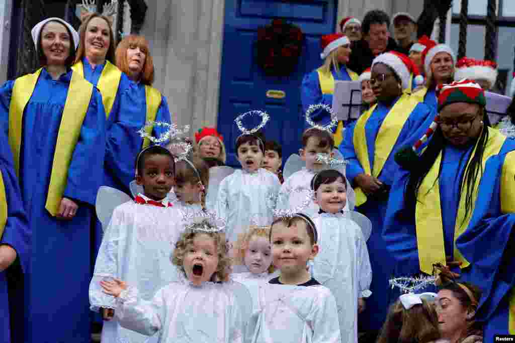 Children from St. Joseph&#39;s nursery sing alongside Lucan Gospel Choir at a live animal Christmas nativity crib, in Dublin, Ireland.