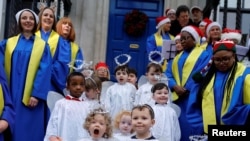 Children from St. Joseph&#39;s nursery sing alongside Lucan Gospel Choir at a live animal Christmas nativity crib, in Dublin, Ireland.