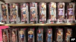 FILE - Barbie dolls are seen inside the new flagship FAO Schwarz store in Rockefeller Plaza in New York, Nov. 16, 2018
