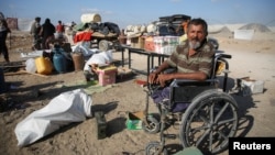 Displaced Palestinians make their way as they flee Hamad City following an Israeli evacuation order, in Khan Younis in the southern Gaza Strip, Aug. 16, 2024.