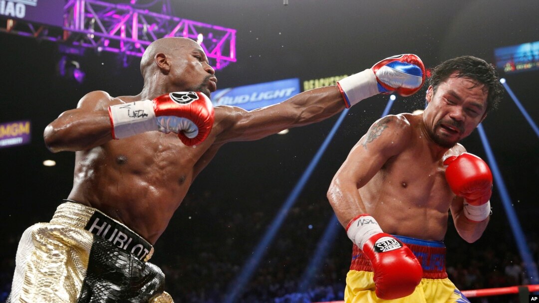 Floyd Mayweather (kiri) memukul Manny Pacquiao dalam "Pertarungan Abad Ini" di Las Vegas (2/5). (AP/John Locher)