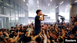 Pro-democracy activist Joshua Wong addresses the crowds outside the Legislative Council during a demonstration demanding Hong Kong's leaders step down and withdraw the extradition bill, in Hong Kong, June 17, 2019.