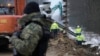 FILE - Workers build the first part of a wall intended to block migrants pushed by Belarus, in what the European Union calls a "hybrid attack," from crossing illegally into EU territory, in Tolcze, near Kuznica, Poland, on the border with Belarus Jan. 27, 2022.