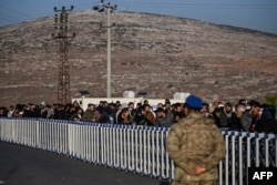 Syrians living in Turkey wait to cross the border at Cilvegozu gate into Syria at Reyhanli district in Hatay, Turkey, on Dec. 9, 2024.