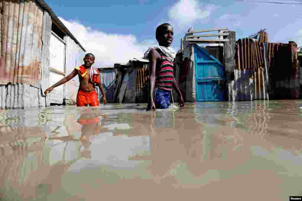 Somali children wade through flood waters after heavy rain in Mogadishu.