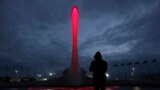 A lighting technician watches the rings form in a fountain at the base of the Olympic cauldron as preparations continue at the Olympic Park for the Sochi 2014 Winter Olympics in Russia.