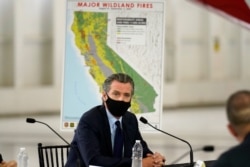 California Gov. Gavin Newsom listens during a briefing with President Donald Trump at Sacramento McClellan Airport, in McClellan Park, Calif., Sept. 14, 2020, on the western wildfires.