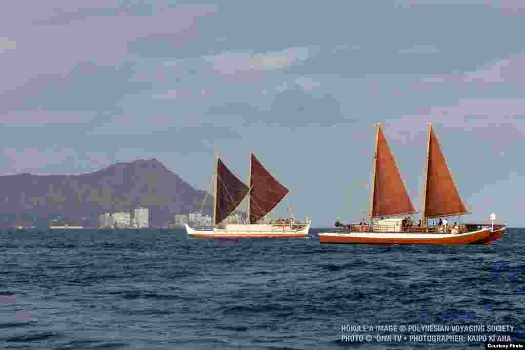 The Hokulea (left) and the Hikianalia sailing off the Hawaiian Islands (date unknown). (Oiwi TV and the Polynesian Voyaging Society)